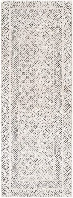 a white rug with an intricate design on the front and back side, in grey tones