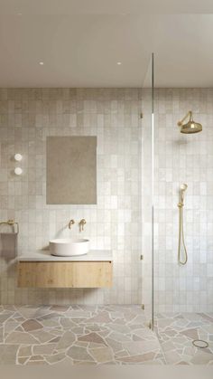 a bathroom with a sink, mirror and shower head in the corner next to it