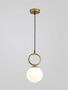 a light hanging from a ceiling fixture with a white ball on the bottom and a black cord