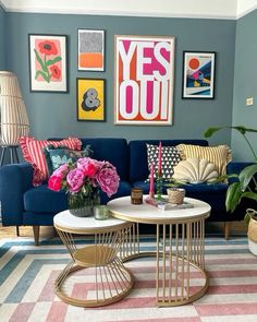 a living room filled with furniture and pictures on the wall above it's coffee table