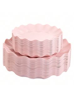 two pink cake pans sitting on top of each other