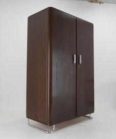 a wooden cabinet sitting on top of a white floor