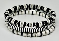 Set of 3 Black and White, hand beaded, stretch bracelets. Each strand is made with 6mm Heishi beads with silver accents. Can be customized with wording of your choice. Stanley Cup option now available. Bracelet Perle Heishi Homme, Black And White Clay Bracelet, Heishi Bracelet Patterns, Black And White Clay Bead Bracelet, Flat Beads, Western Clay Bead Bracelet Ideas, Black Beads Bracelet, Black And White Bracelets, Bracelet Heishi