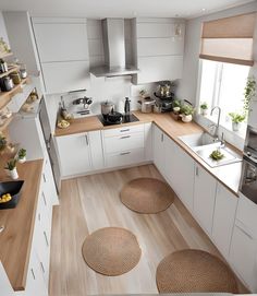 the kitchen is clean and ready for us to use it's natural wood flooring