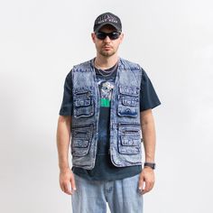 Vintage 90's cargo style denim vest in stonewashed blue - with a front zip - features four main pockets and several smaller ones - materials: denim SIZE from the tag: L MEASUREMENTS chest: 44 inches (112 cm) length: 29 inches (73 cm) The model is 6'1" (186 cm), measures 41-35-39 (104-88-100 cm) and typically wears clothing in size L CONDITION: 9/10 - The vest in great vintage condition. Washed, ready to wear. Summer Streetwear Vest With Pockets, Utility Vest With Pockets For Streetwear, Casual Cargo Pocket Vest For Streetwear, Casual Streetwear Vest With Cargo Pockets, Casual Medium Wash Vest With Pockets, Casual Vest With Pockets In Medium Wash, Sleeveless Denim Vest With Pockets For Streetwear, Casual Streetwear Vest With Multiple Pockets, Casual Streetwear Vest With Pockets