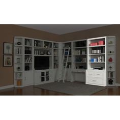 a living room with white bookcases and shelves filled with books on top of them