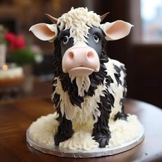 a cake shaped like a cow sitting on top of a table