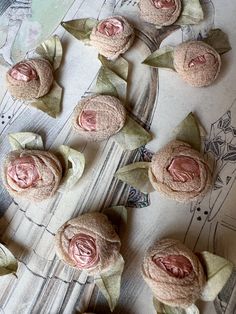 several small pink flowers sitting on top of a table