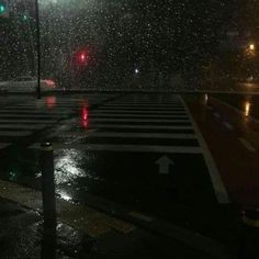 an empty cross walk in the rain at night