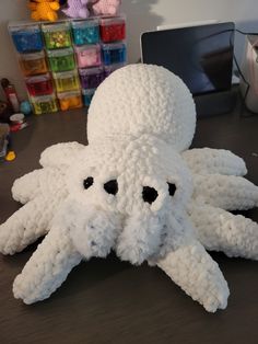 an octopus stuffed animal sitting on top of a table