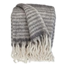 a gray and white blanket with fringes