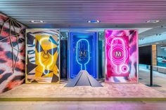 three brightly colored doors are in the middle of a room that has graffiti on it