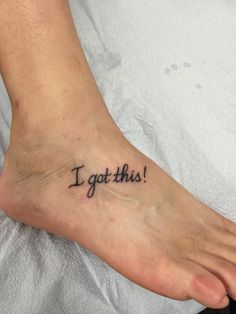 a foot with the words i got this tattooed on it's left side leg