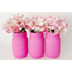 three pink mason jars with flowers in them