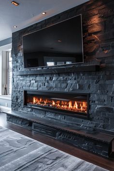 a large stone fireplace with a flat screen tv mounted above it's mantle in a living room