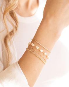 Elevate your outfit with the Lily Bracelet. This chunky pearl bracelet is a must-have addition to any fun and chic outfit. With an extender for easy wearing, it is one of our favorites. Stacked here with our Chloe Bracelet, Camilla Bracelet, and our Devon Bracelet. The sister to this is our Lily Necklace! Details: - Gold Filled - 2" extender Classic Pearl Bracelet With Extender, Chic Adjustable Pearl Bracelet With Pearl Charm, Chic Adjustable Pearl Bracelet With Charm, Chic Adjustable Bracelet With Pearl Charm, Chic Adjustable Bracelets With Pearl Charm, Elegant Pearl Bracelet With Extender, Party Pearl Drop Beaded Bracelets, Lily Bracelet, Lily Necklace