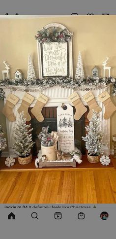 a fireplace decorated for christmas with stockings and trees