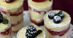 small desserts with berries and powdered sugar on them