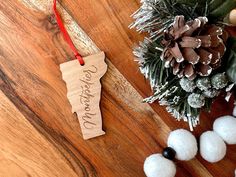 a wooden ornament with the word merry christmas hanging from it's side