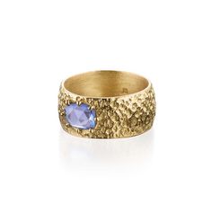 18k Fairmined gold, textured wide band ring with a cast in place, rose cut, blue sapphire. Handcrafted ocean inspired fine jewelry made with love in New York City. This bold ring stacks perfectly and would make a uniquely gorgeous wedding band. The 18k Fairmined gold is hand textured to evoke the natural beauty of the beach and capture the sparkling sun on the ocean. Metal: Recycled 18k yellow gold Stones: Rose cut, faceted blue sapphire (1.5ct.) - Responsibly sourced This piece offers a comfort Wide Gold Band, Gorgeous Wedding Bands, Ring Stacks, Wide Band Ring, On The Ocean, Bold Rings, Spiral Earrings, Daisy Earrings, Ocean Inspired