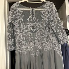 a dress hanging on a hanger in a closet