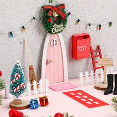 a christmas scene with a pink door and red mailbox