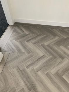 an empty room with wood flooring and a mirror on the floor next to it