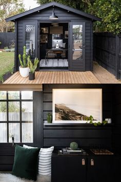 the outside of a house that has been painted black and is decorated with green accents