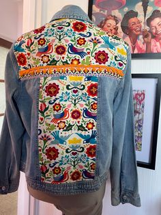 Size L Reworked denim jacket with beautiful embellished back and front panels Two chest pockets and front button fastenings. Decorative back with gorgeous multi coloured fabric and trimmings.  I up-cycle second-hand/new  denim jackets and give them a new lease of life by adding beautiful ribbons, braid and embroidered textiles.  Each piece is hand picked and lovingly re-worked to create a hippie unique jacket. I design each piece unique so you will never find two the same.  I am happy to work on Multicolor Patchwork Cotton Denim Jacket, Multicolor Cotton Patchwork Denim Jacket, Multicolor Patched Denim Jacket For Spring, Multicolor Denim Jacket With Patches For Spring, Multicolor Bohemian Cotton Denim Jacket, Multicolor Bohemian Denim Jacket, Bohemian Multicolor Long Sleeve Denim Jacket, Multicolor Cotton Denim Jacket With Pockets, Multicolor Denim Jacket For Festivals