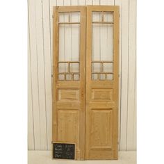 an old wooden double door with glass inserts