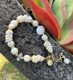 Large freshwater baroque pearl in the centre following through with shells, crystals white howlite stones and a large conch shell, attached with a gold crab claw clasp, extra chain for sizing.  8.5 inches long Crystals White, Crab Claw, Howlite Stone, White Howlite, Shell Bracelet, Conch Shell, Baroque Pearls, Conch, Crab