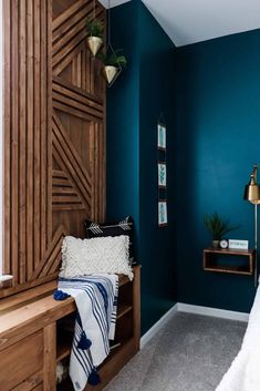 a bedroom with blue walls and wooden furniture