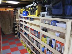 the inside of a garage with shelves and tools