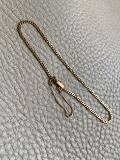 A great budget friendly silky pressed curb link bracelet! Made in 1942 from solid 18k gold, this vintage piece measures 7.5" long and has the silkiest movement. Box clasp is well working with both a safety loop and safety chain. Hallmarked for year, gold purity and the triple crown for Sweden.Excellent vintage condition with normal age related wear. Details Made in 1942 7.5 inch length 2mm width 2.7 grams 18k gold (solid, not plated or fill) Marked for maker, year, gold purity, and the triple cr Formal Vintage Gold Bracelet With Curb Chain, Vintage Yellow Gold Curb Chain Bracelet, Vintage Gold-tone Chain Bracelet, Vintage Hallmarked Yellow Gold Chain Bracelet, Vintage Gold-tone Jubilee Chain Bracelet, Vintage Gold Necklace, Safety Chain, Triple Crown, Box Clasp