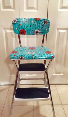 a blue and red chair sitting in front of a white door