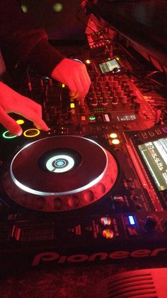 a dj mixing music at a party in the dark