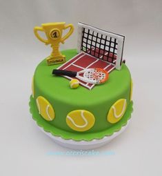 a tennis themed cake with a trophy and racket