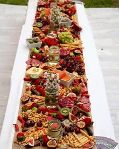 a long table filled with lots of different types of food on it's sides