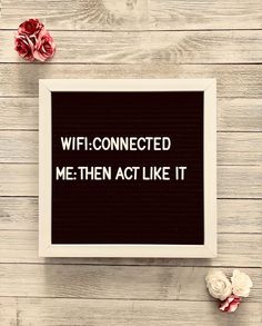 a framed sign that says wifi - connected me then act like it on a wooden table