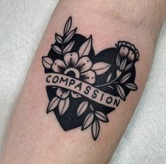 a black and white tattoo with the words compassion on it