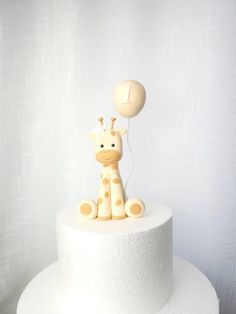 a giraffe cake with a balloon on top