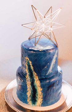 a blue and gold cake with a star on top