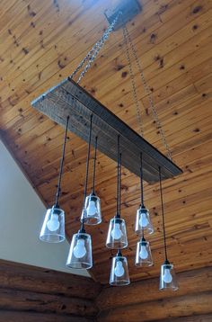 a chandelier hanging from a wooden ceiling