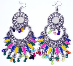 Chunky hippie drop earrings in silver-tone with multicolor beads, enamel and mirror inserts. It is a tribal jewelry look-a-like design that has detailing around it with colorful beads hanging from it. Perfect accessory for outdoor summer festivals to jazz up your outfits. Multicolor Metal Earrings For Festivals, Traditional Multicolor Metal Earrings, Multicolor Metal Earrings With Dangling Beads, Multicolor Teardrop Jewelry For Festivals, Teardrop Multicolor Jewelry For Festivals, Bohemian Multicolor Earrings With Oxidized Finish, Bohemian Multicolor Oxidized Earrings, Bohemian Multicolor Oxidized Finish Earrings, Hippie Multicolor Dangle Jewelry