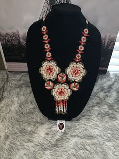 an elaborate necklace is displayed on a mannequin