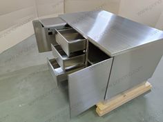 an empty metal cabinet with drawers in the middle