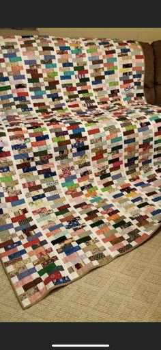 a couch that has a quilt on it