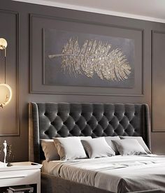 a bedroom with a bed, nightstands and pictures on the wall above it in grey tones