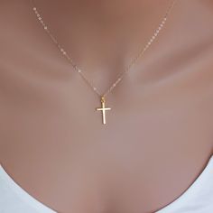 A Simple Real Gold Cross dangle from a delicate chain . Dainty thicker cross necklace made of solid 14KT Yellow Gold on a delicate cable chain or box chain or rope chain with spring clasp. This 14-karat yellow gold cross charm features a simple, classic design and bright finish. Model is wearing an 16" length. Necklace length can be different, depends on your high and weight.  Ideal For: Daily wear to keep your faith close Special religious occasions like First Communions or Confirmations A mean Yellow Gold Cross Necklace, Cross Necklace Simple, Necklaces Ideas, Gold Cross Necklace, Gold Cross Pendant, Cross Jewelry, Gold Cross, Cross Charms, Cross Pendant Necklace