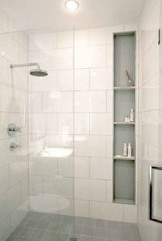 a bathroom with a shower, toilet and shelves on the wall next to each other